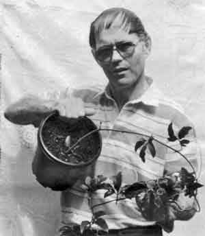 Photo of Hans Muller holding an Oyster Nut Plant in a pot.